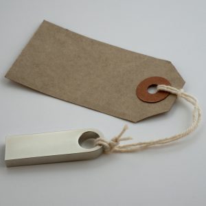 A minimalist paper tag with twine string on a neutral background, ideal for product labeling.